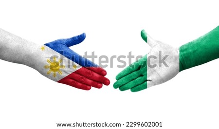 Handshake between Nigeria and Philippines flags painted on hands, isolated transparent image.