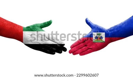 Handshake between Haiti and UAE flags painted on hands, isolated transparent image.