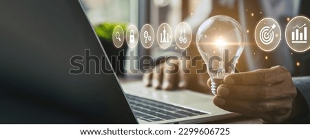 Close up hand choose light bulb or lamp with bright for human resources or leadership and creativity thinking idea motivation or vision and knowledge learning. Royalty-Free Stock Photo #2299606725