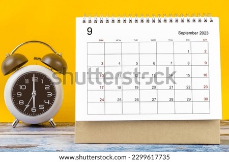 September 2023 Monthly desk calendar for 2023 year and alarm clock.