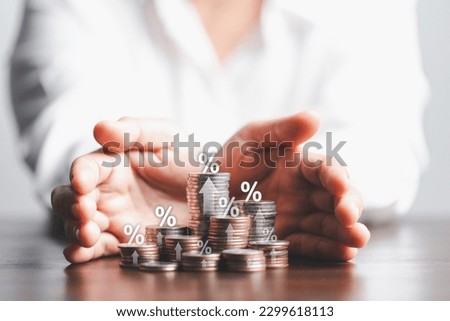 Businesswoman hand giving heap of coins money with up arrow and percentage symbol of Interest rate financial and mortgage rates. Icon percentage symbol and arrow pointing up.