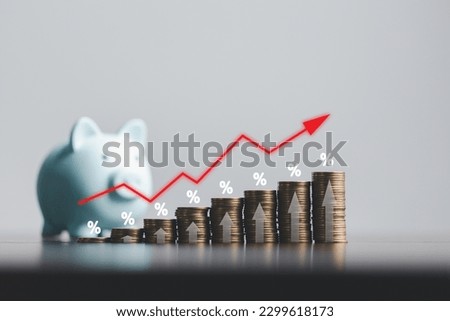 Stacked coins on wooden table with illustration shows increasing of interest rates, financial concept. Interest rate financial and mortgage rates. Icon percentage symbol and arrow pointing up.
