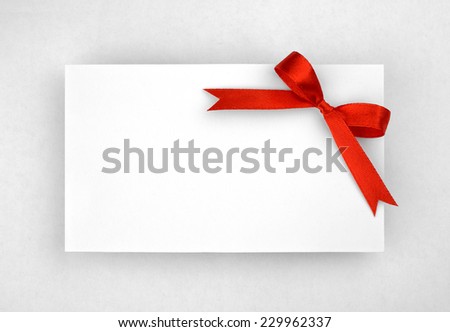 Red silk bow on empty paper card