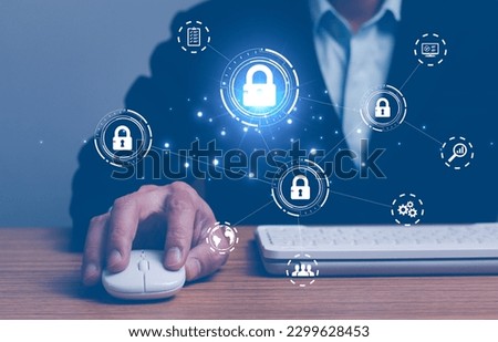 Business, technology, internet and networking concept. Young businesswoman working on his laptop in the office, select the icon security on the virtual display.