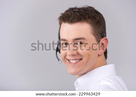 Call center male operator isolated on white. Closeup portrait of young man with headset isolated on grey background 