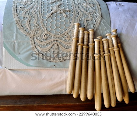 Spindles and threads composing traditional embroidered lace in Sicily, Italy