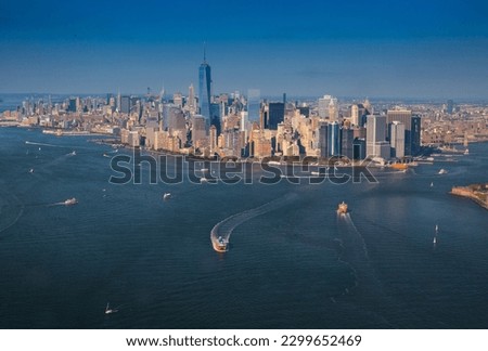 Stunning aerial view of New York City's downtown skyline with helicopters soaring above iconic skyscrapers and bustling streets.