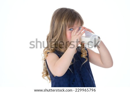 little kid drinks genuine glass of milk