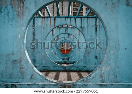 The iconic blue circular walls of Lok Wah South Estate Parking are photographed in a recursive pattern. Royalty-Free Stock Photo #2299659051