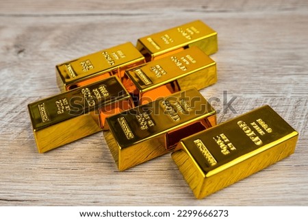 gold bars on a wooden table.