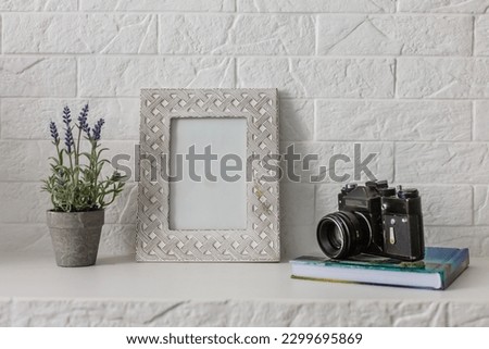 Home office concept. Empty wooden picture frame mockup. White wall background. Scandinavian interior design.