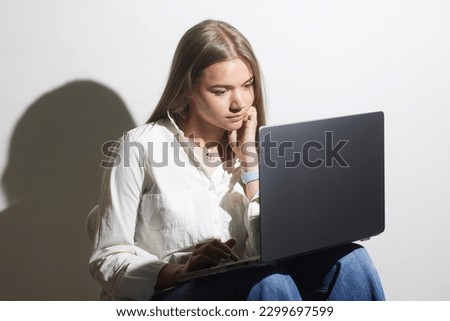 tired girl with laptop on white background