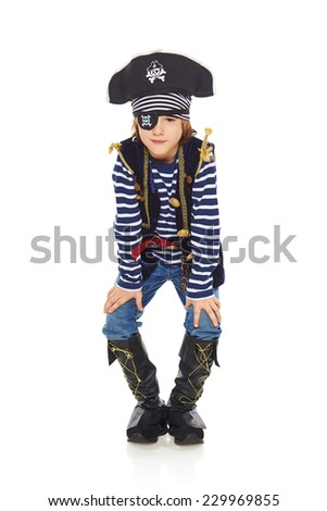 Full length grinning little boy wearing pirate costume, over white background