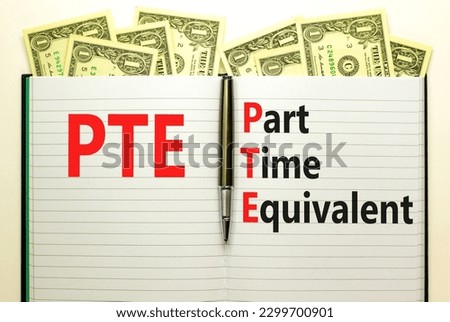 PTE Part time equivalent symbol. Concept words PTE Part time equivalent on white note. Dollar bills. Beautiful white table white background. Business and PTE Part time equivalent concept. Copy space.