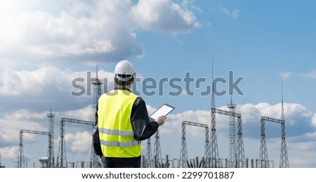 Worker with digital tablet on a background of power station

 Royalty-Free Stock Photo #2299701887