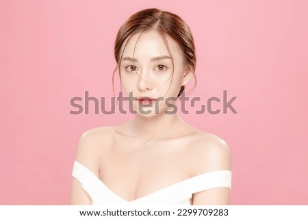 Young Asian beauty woman pulled back hair with korean makeup style on face and perfect skin on isolated pink background. Facial treatment, Cosmetology, plastic surgery.
