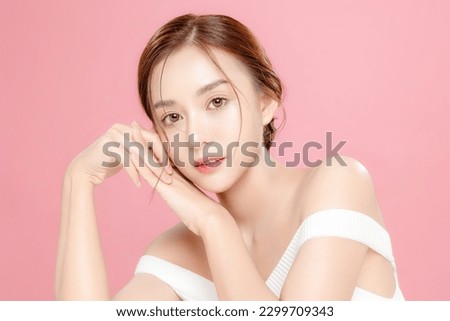 Young Asian beauty woman pulled back hair with korean makeup style on face and perfect skin on isolated pink background. Facial treatment, Cosmetology, plastic surgery. Royalty-Free Stock Photo #2299709343