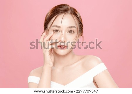Young Asian beauty woman pulled back hair with korean makeup style touch her face and perfect skin on isolated pink background. Facial treatment, Cosmetology, plastic surgery. Royalty-Free Stock Photo #2299709347