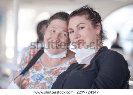Portrait of two women mom and daughter laughing on a summer day