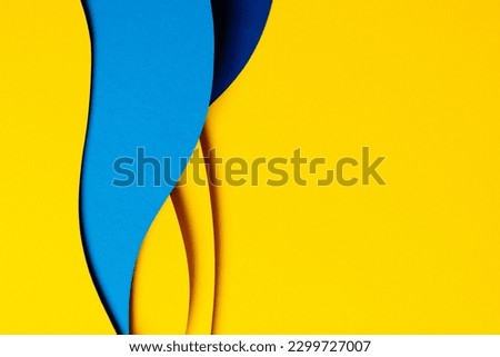 Abstract colored paper texture background. Minimal paper cut composition with layers of geometric shapes and lines in light blue, navy blue, yellow colors