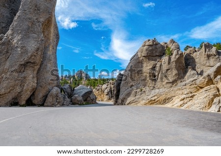 The Needles Highway is a spectacular drive through pine and spruce forests, meadows surrounded by birch and aspen, and rugged granite mountains. Part of Peter Norbeck Scenic Byway. Royalty-Free Stock Photo #2299728269