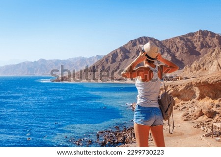 Tourist woman in Dahab near Blue Hole at the Red Sea coast, Egypt Royalty-Free Stock Photo #2299730223