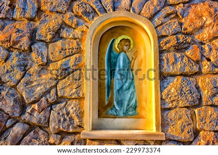 Angel picture in aedicula on house stone wall in Medjugorje in Bosnia ed Erzegovina