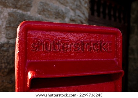 A pillarbox red postbox owned by the post office for posting letters Royalty-Free Stock Photo #2299736243