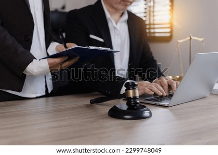 Close-up of asian lawyer and client discussing at office desk, law and justice concept. 