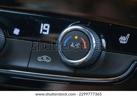 Close up air conditioner buttons inside car.  Royalty-Free Stock Photo #2299777365