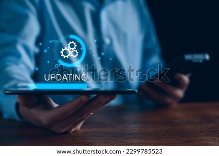 Operating system upgrade concept, installation app and software update process, modernize user equipment, update modern functions, developer released new version Improved security. User is downloading Royalty-Free Stock Photo #2299785523