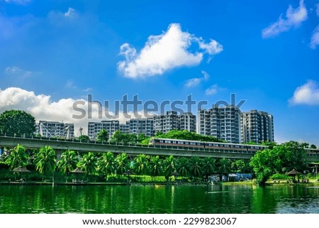 MRT Train passing with The Estuary codo in the background, Yishun Town, Singpore. Royalty-Free Stock Photo #2299823067