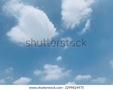 The sky has high pressure and moving in to replace hot air A small white cloud appeared. Imagine like a nemo fish spread across the beautiful sky at Bangkok, Thailand, no focus