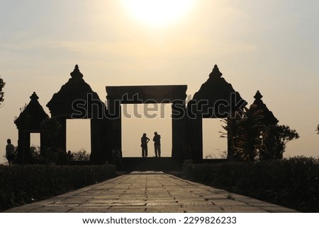 silhouette of the entrance gate of the Ratu Boko Palace with the activities of several tourists