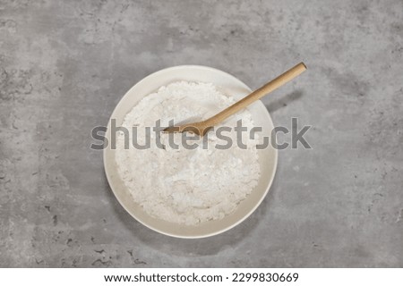 Top view of  a white bowl with powdered monkfruit sweetener with erythritol for sugar free baking.