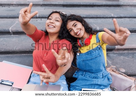 portrait of two young latin girls university students in Mexico Latin America, hispanic girls studying  Royalty-Free Stock Photo #2299836685