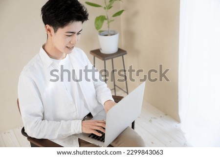 Image of an Asian college student using a computer to study