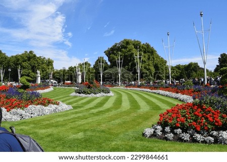 The beautifully pristine gardens surrounding Buckingham Palace with vibrant green grass and stunning flowers of all different colors Royalty-Free Stock Photo #2299844661