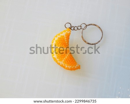 Fruit key chain on a white background. Fruit colorful key chain on a white