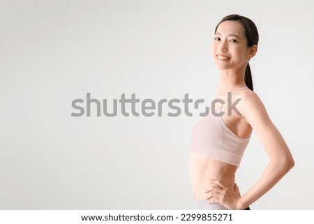 Close-up of a beautiful Asian woman who looks like she could use some exercise.