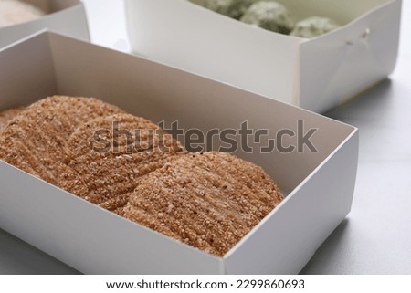 Raw vegan cutlets with breadcrumbs on white table, closeup