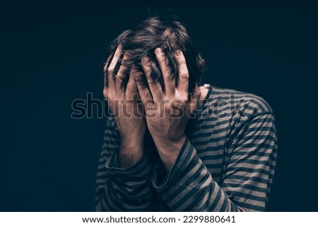 Despair and hopelessness, low key male portrait with selective focus Royalty-Free Stock Photo #2299880641