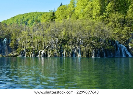 Waterfall cascade at Plitvice lakes in Lika-Senj county, Croatia flowing into Kozjak lake Royalty-Free Stock Photo #2299897643