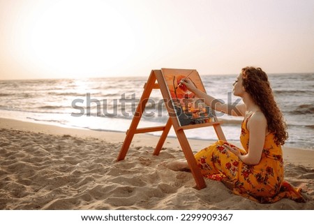 Young woman drawing the picture at the beach. Hobby and leisure concept. Talent and creativity. Canvas Painting.