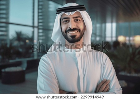 Happy Emirati Arab at office wearing Kandura looking at front ideal for Middle East business concept