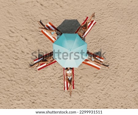 beautiful young women lying on the beach sunbathing in swimming suites, relaxing and enjoying. Royalty-Free Stock Photo #2299931511