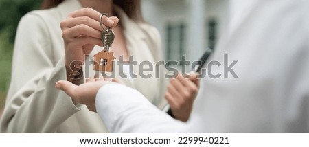 lease, rental and selling home. Real estate agent manager smile holding key for new owner.  rent house, Sales, loan credit financial, insurance, Seller, dealer, installment,  buy, sell, move in Royalty-Free Stock Photo #2299940221