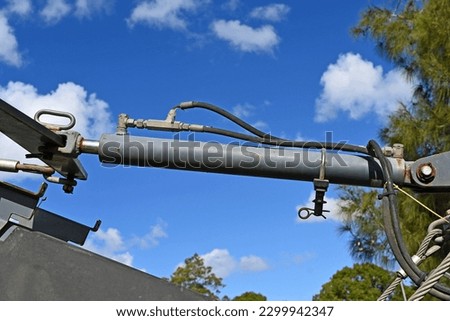 Steel hydraulic ram on a large piece of machinery Royalty-Free Stock Photo #2299942347