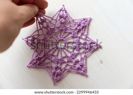 Purple crochet doily. This photo has been taken in Prague, 2023