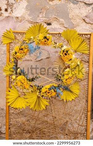 vintage frame decorated with spring flowers on it and old plaster in the background